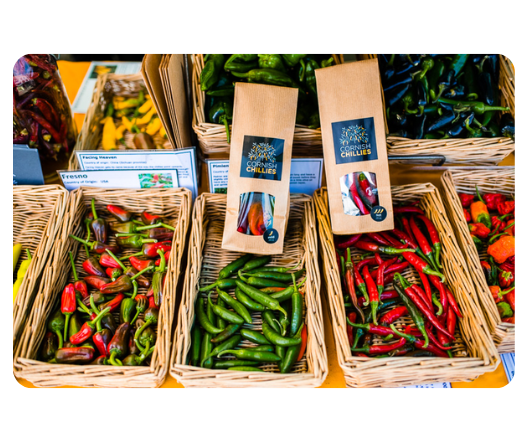 Bottles of ultra-hot Cornish Chillies sauce showcasing one of the hottest chilli sauces in the UK, displayed with bold fiery graphics.