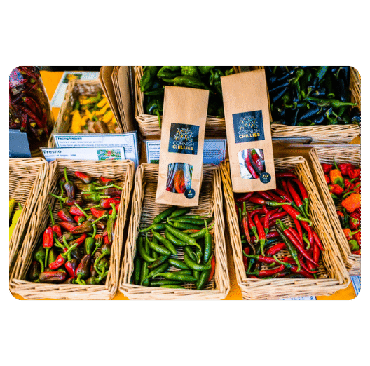 Bottles of ultra-hot Cornish Chillies sauce showcasing one of the hottest chilli sauces in the UK, displayed with bold fiery graphics.
