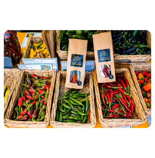 Bottles of ultra-hot Cornish Chillies sauce showcasing one of the hottest chilli sauces in the UK, displayed with bold fiery graphics.